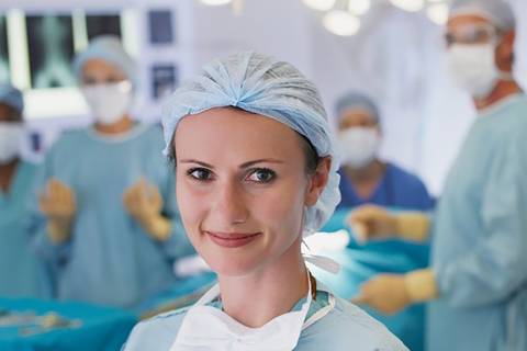 Female surgeon in protective gear