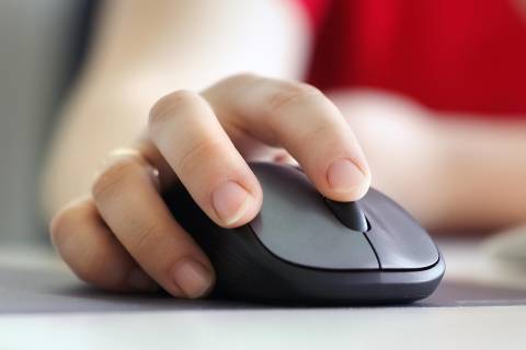 Hand on computer mouse