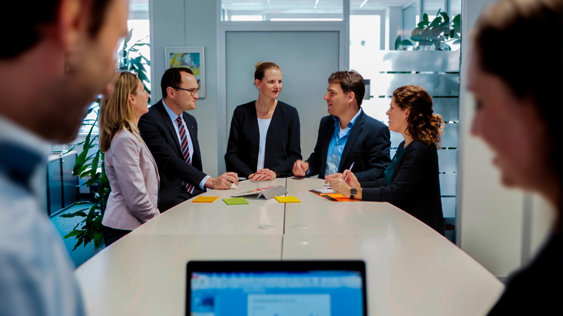 Gruppe im Gespr&auml;ch an Stehtisch