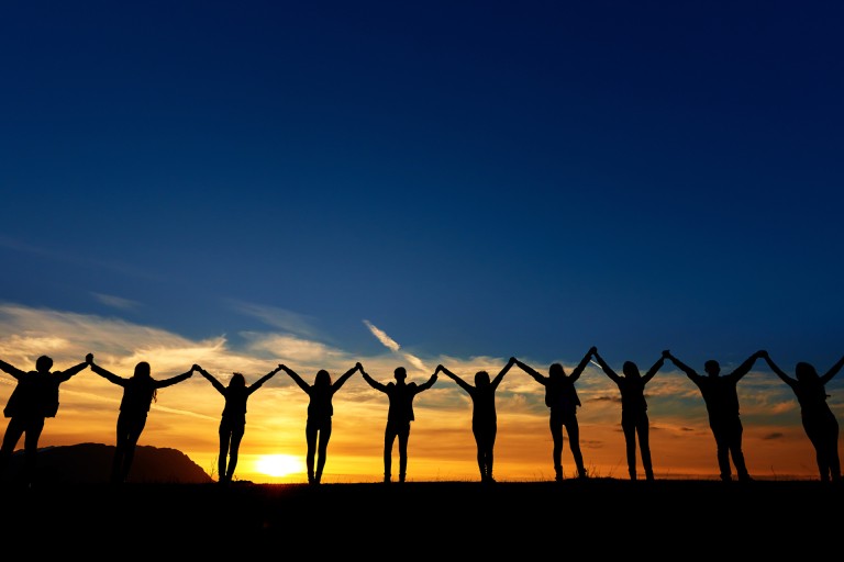 chain of people at sunrise