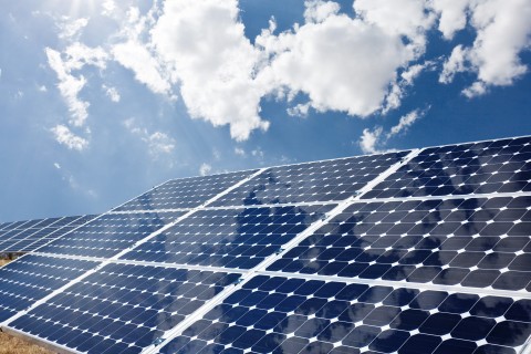 Solar panels with sunny sky in the background