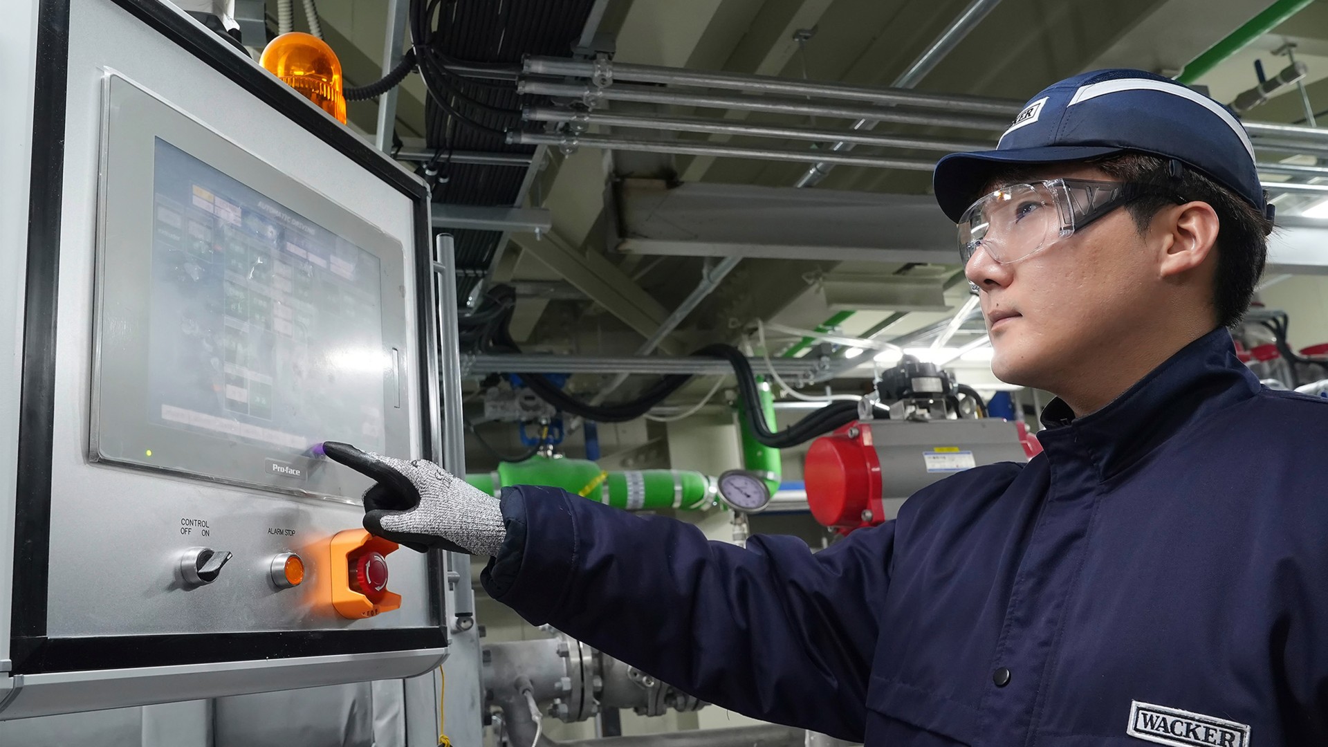 A production worker at the plant in Jincheon sets the required parameters on a display