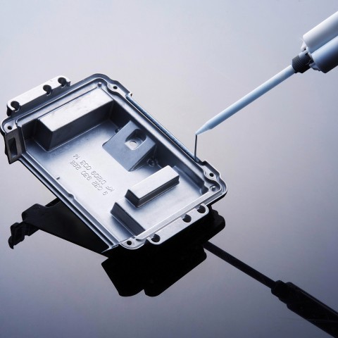 Close-up of a component being filled with silicone