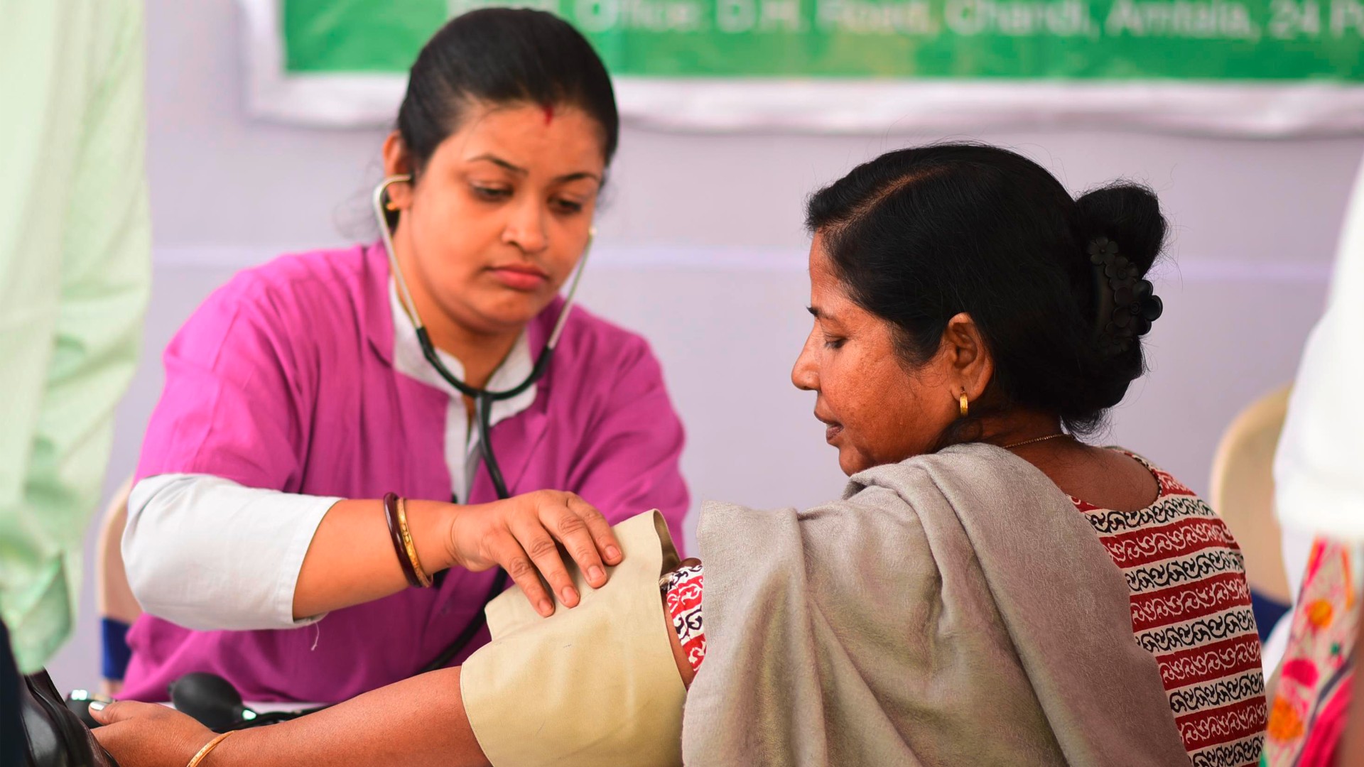 A female doctor measures the blood pressure of a female patient