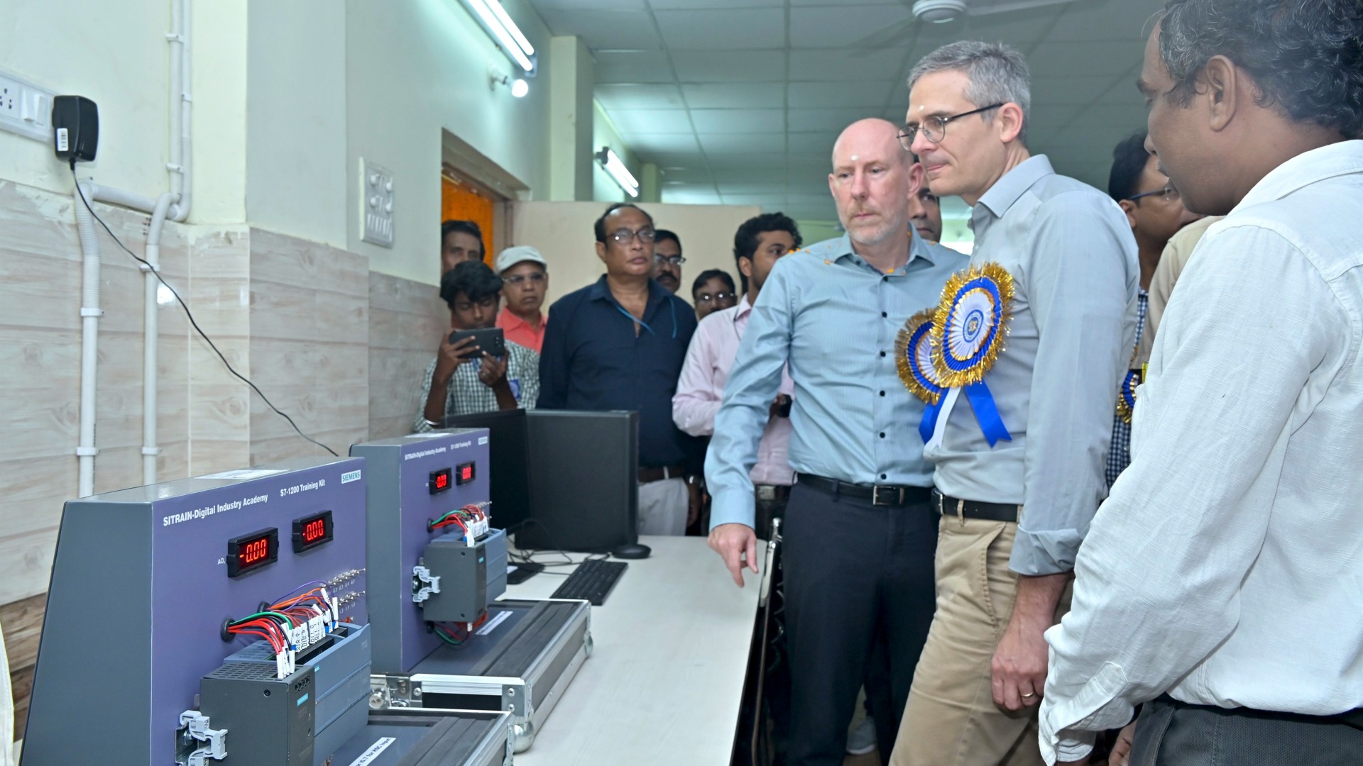 Several men are given a tour of the laboratory