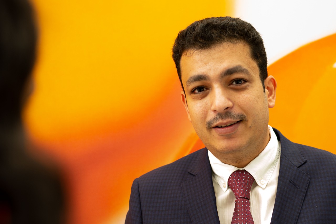Mohammed Sanaobar against an orange background