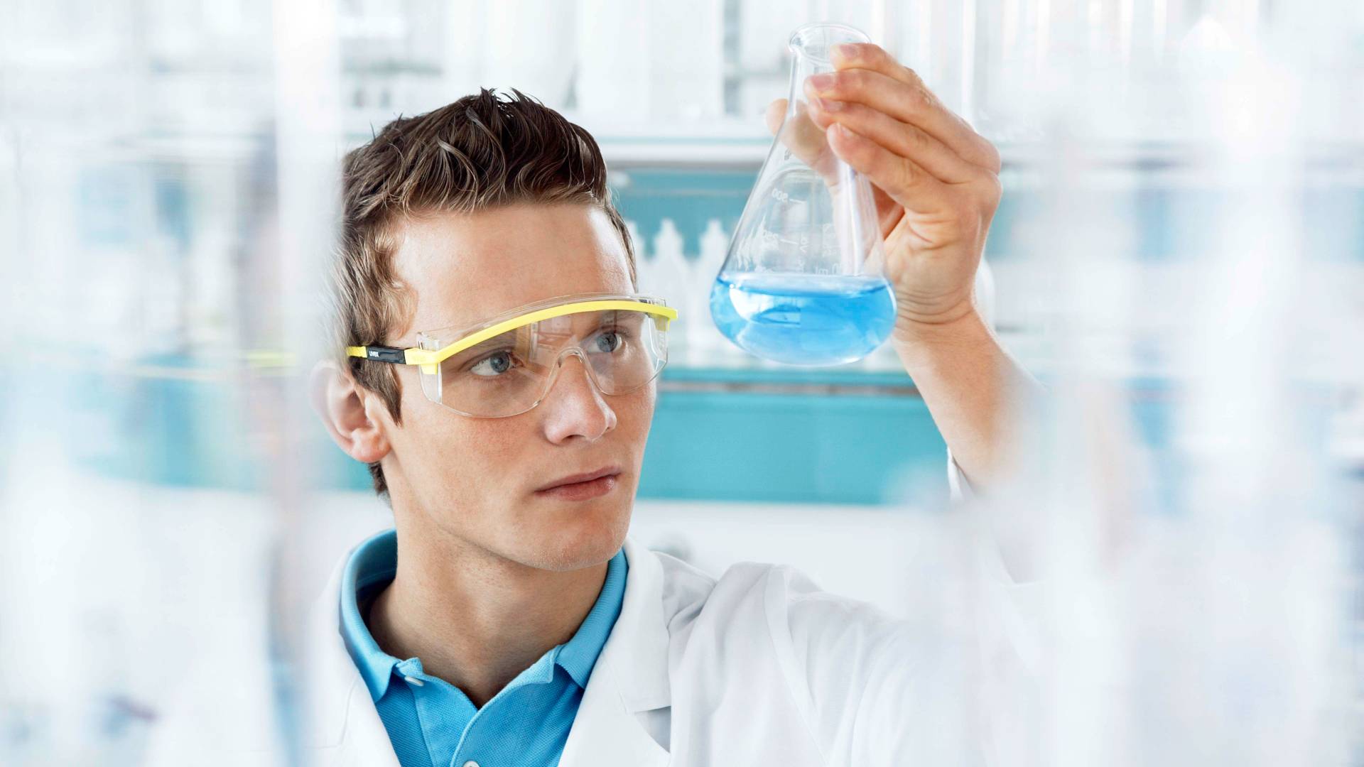 Lab technician holding conical flask