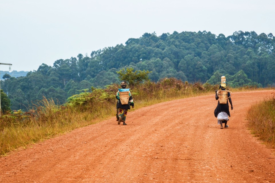 Two women on a road made of laterite