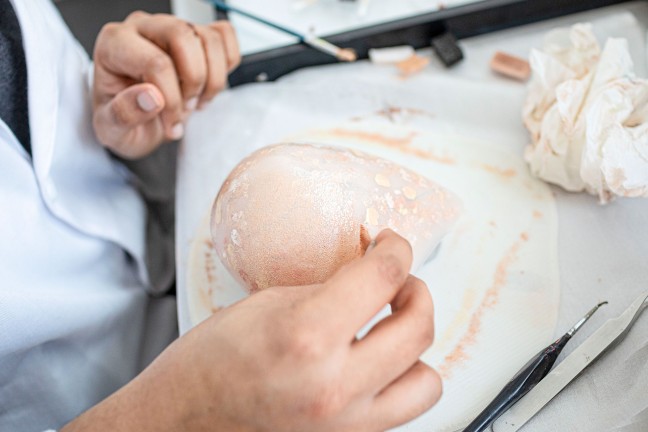 A breast implant is being worked on.