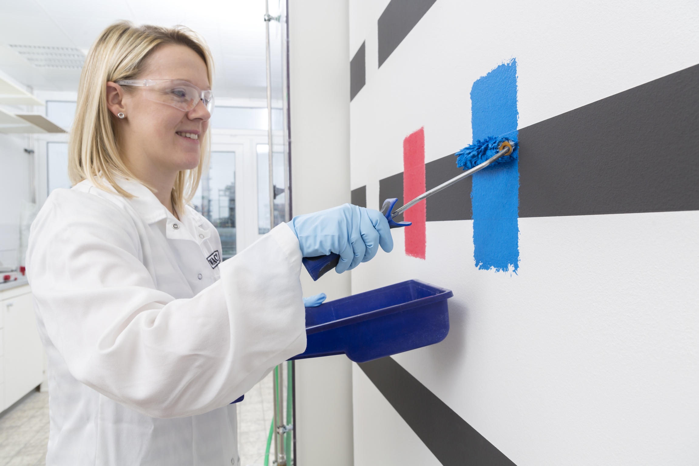 A WACKER lab assistant checks the hiding power of paint