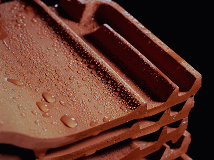 Water rolls off ceramic roof tiles that have been impregnated with silicone resins.